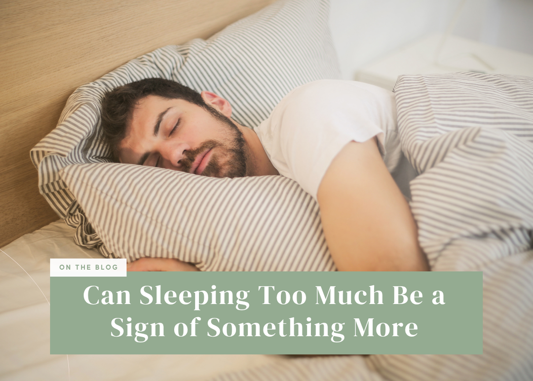 Person sleeping in bed with striped bedding.