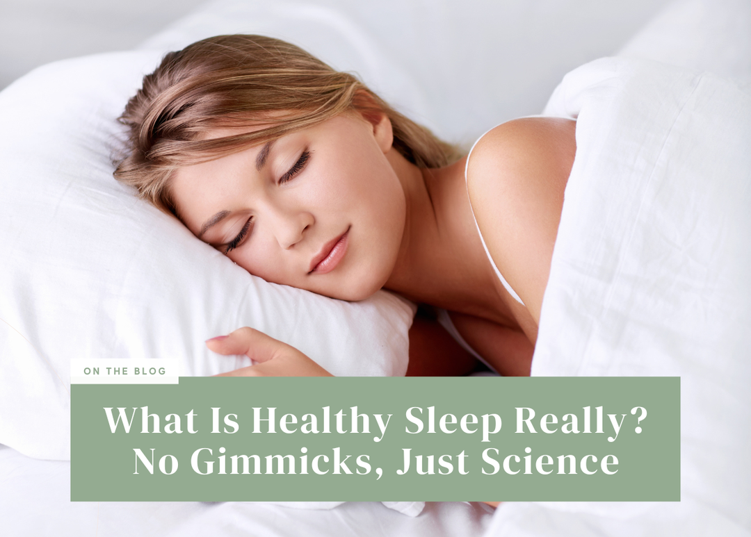 Woman sleeping soundly on a plush pillow tucked under white sheets.