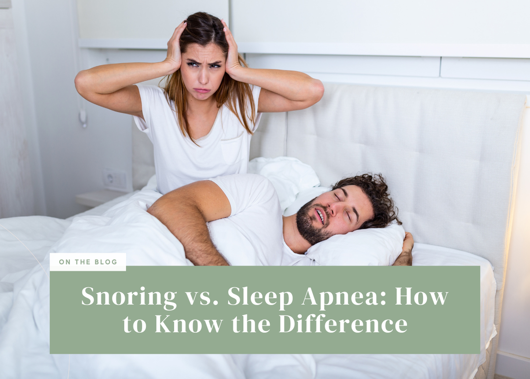 Frustrated woman sitting up in bed covering her ears beside a sleeping partner.