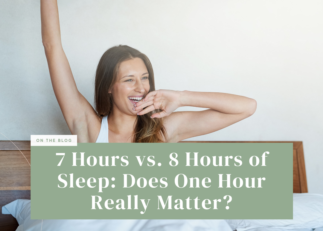 Smiling woman yawning and stretching one arm up as she wakes up in bed.