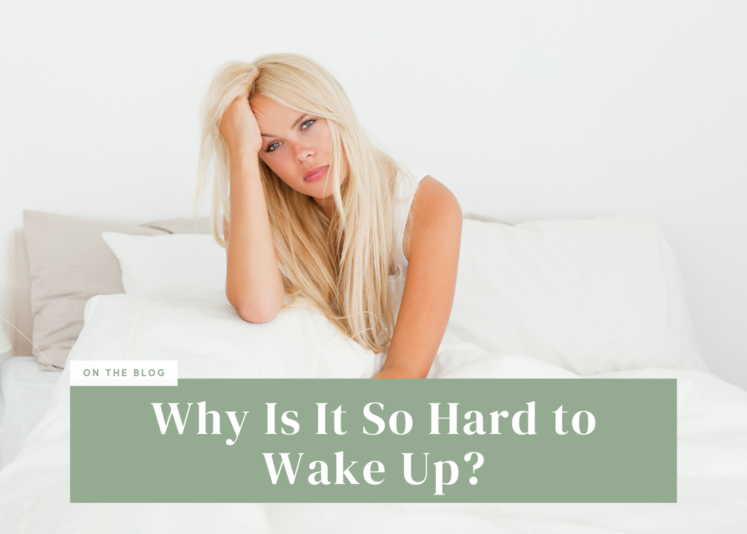 Blonde woman resting her head on her hand with a tired expression while sitting in bed.