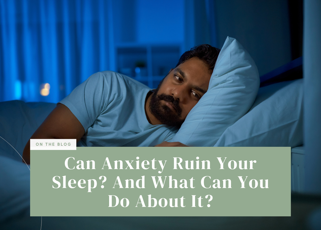 Man lying awake in bed at night dealing with sleep anxiety.