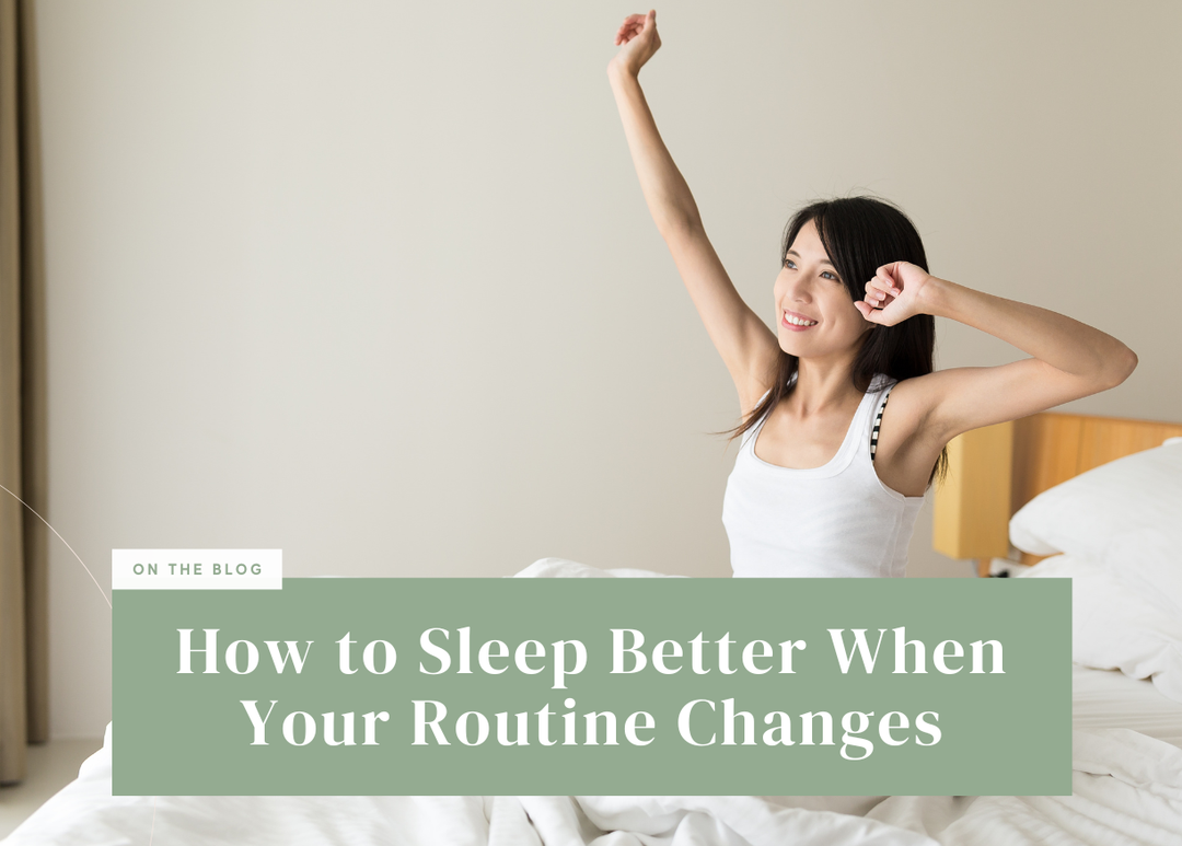Smiling woman sitting up in bed stretching her arms joyfully in the morning.