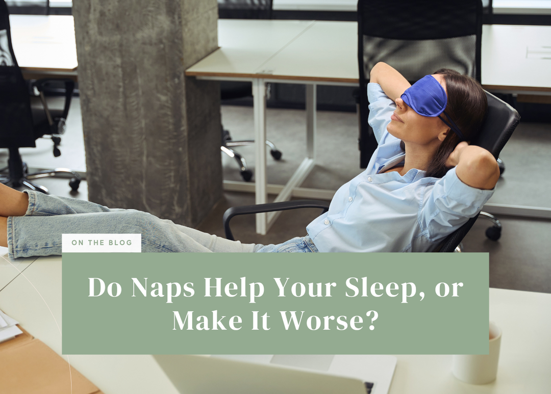 Woman wearing a blue eye mask taking a nap in an office chair with her feet resting on the desk.
