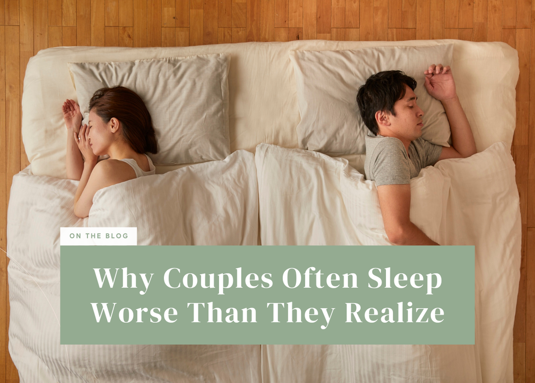 Overhead view of a man and woman sleeping back-to-back on opposite sides of a bed under separate duvets.