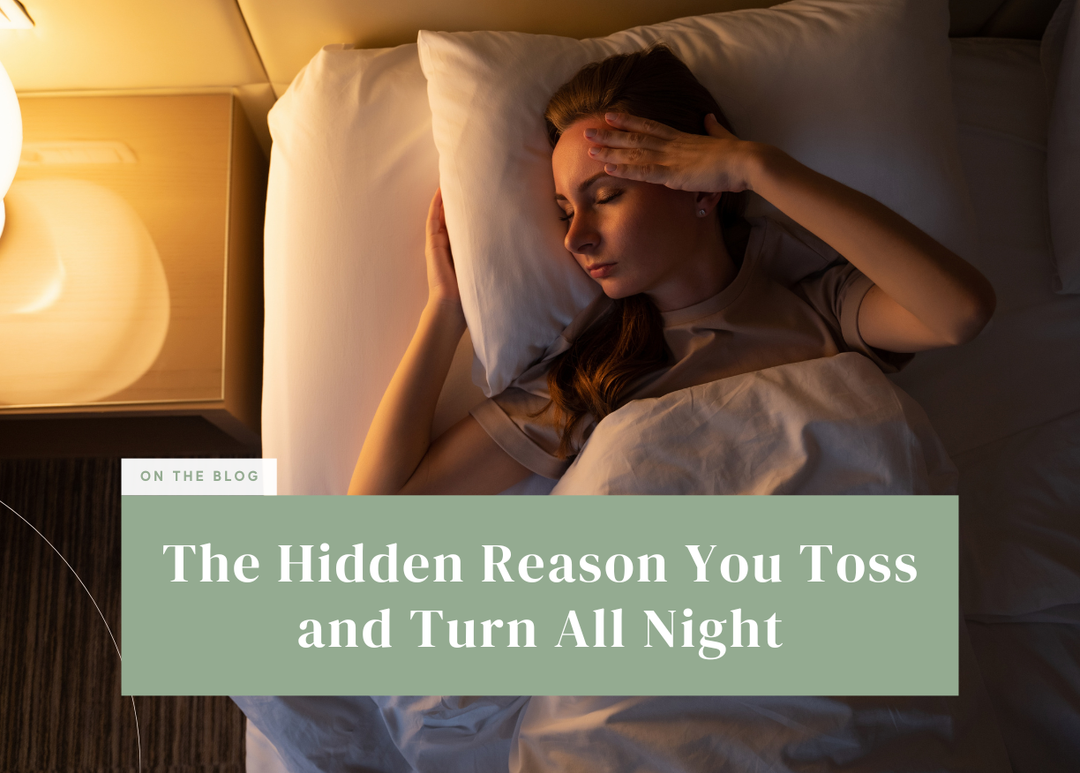 Woman lying in bed with her hand on her forehead, unable to sleep