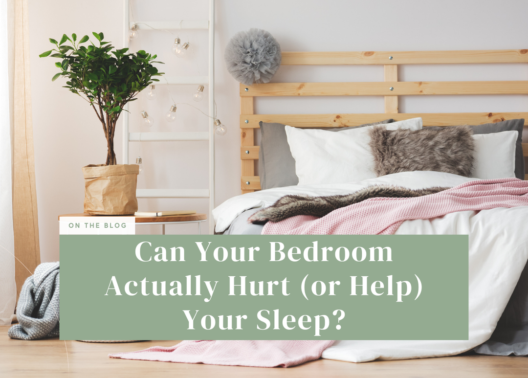 Cozy bedroom set up with a potted plant on a nightstand and a bed made with white and pink blankets.