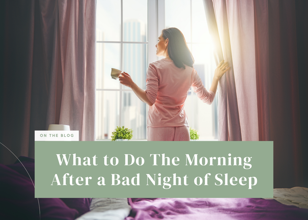 Woman holding a coffee cup while opening bedroom curtains to let in morning light.
