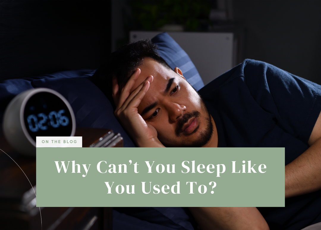 Man lying awake in bed at night resting his head on his hand next to a digital alarm clock.