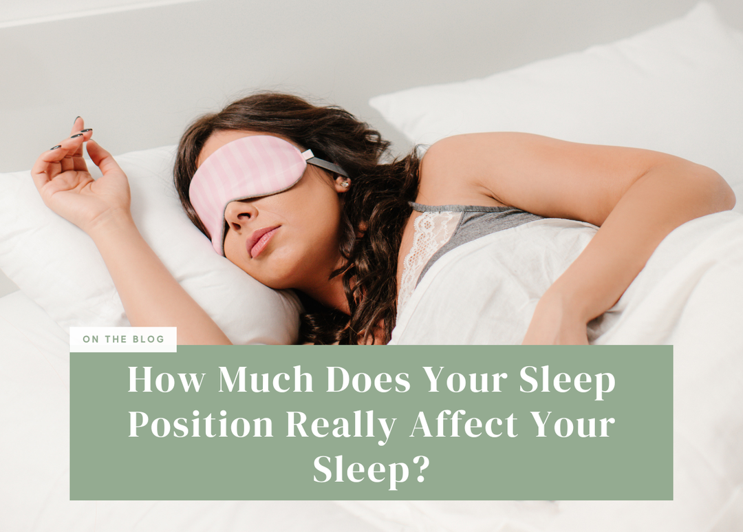 Woman wearing a pink eye mask sleeping in bed.