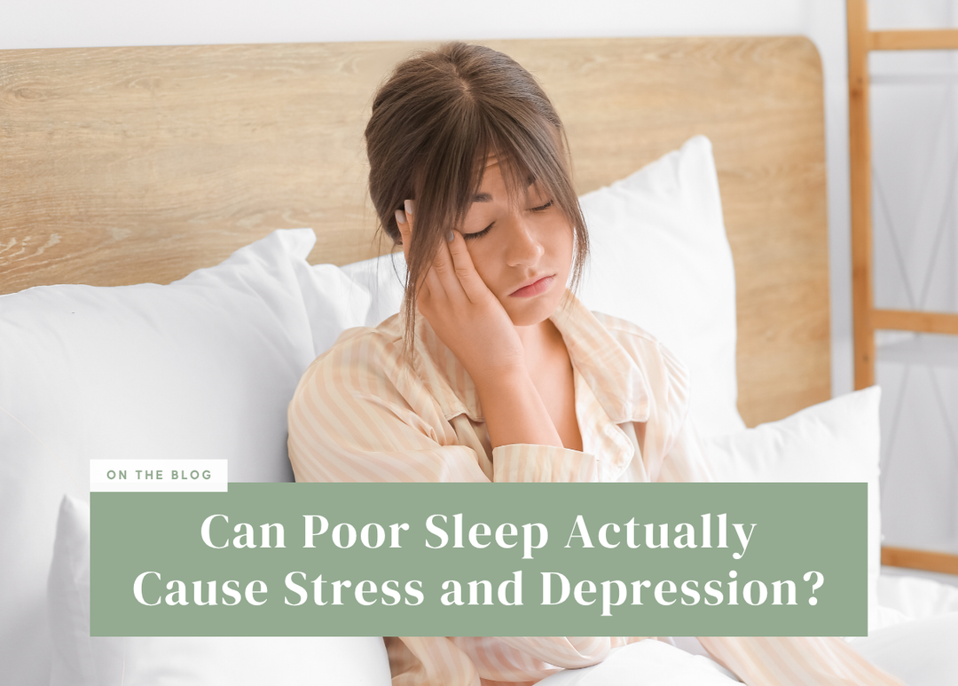 Woman sitting in bed resting her head in her hand, looking stressed.