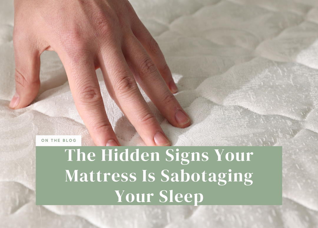 Person pressing their hand into the soft surface of a white tufted mattress.