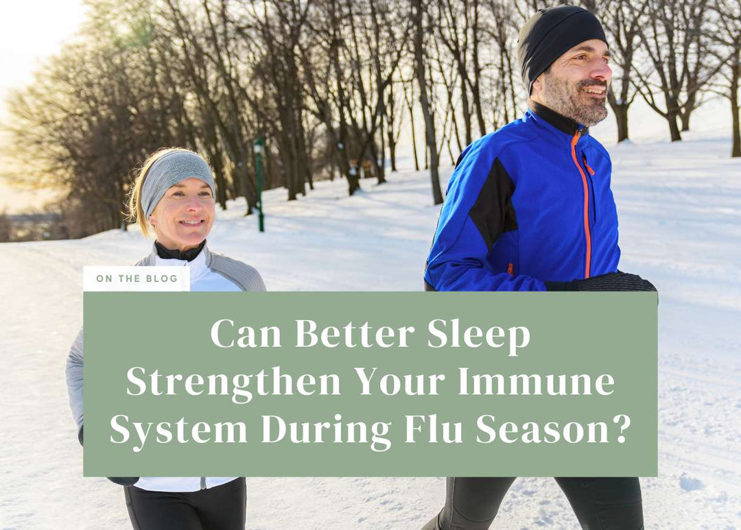 Man and woman jogging together outdoors along a snow-covered path in winter athletic wear.