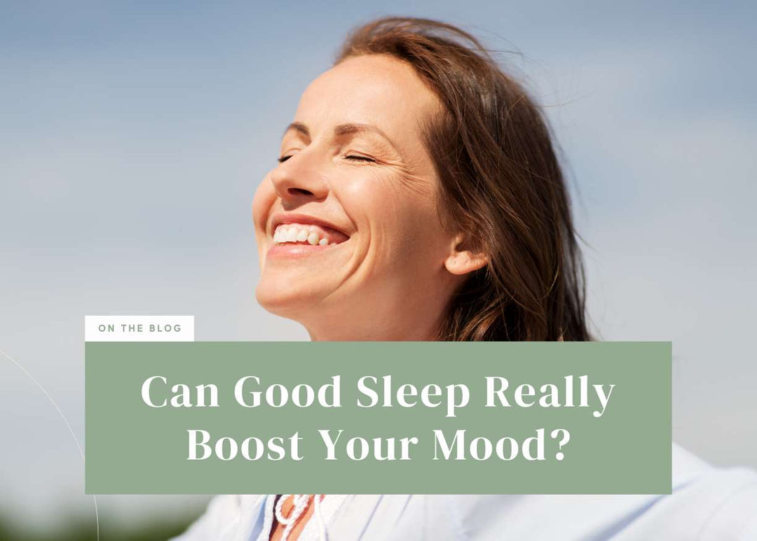 Smiling woman tilting her head back happily under a bright blue sky.