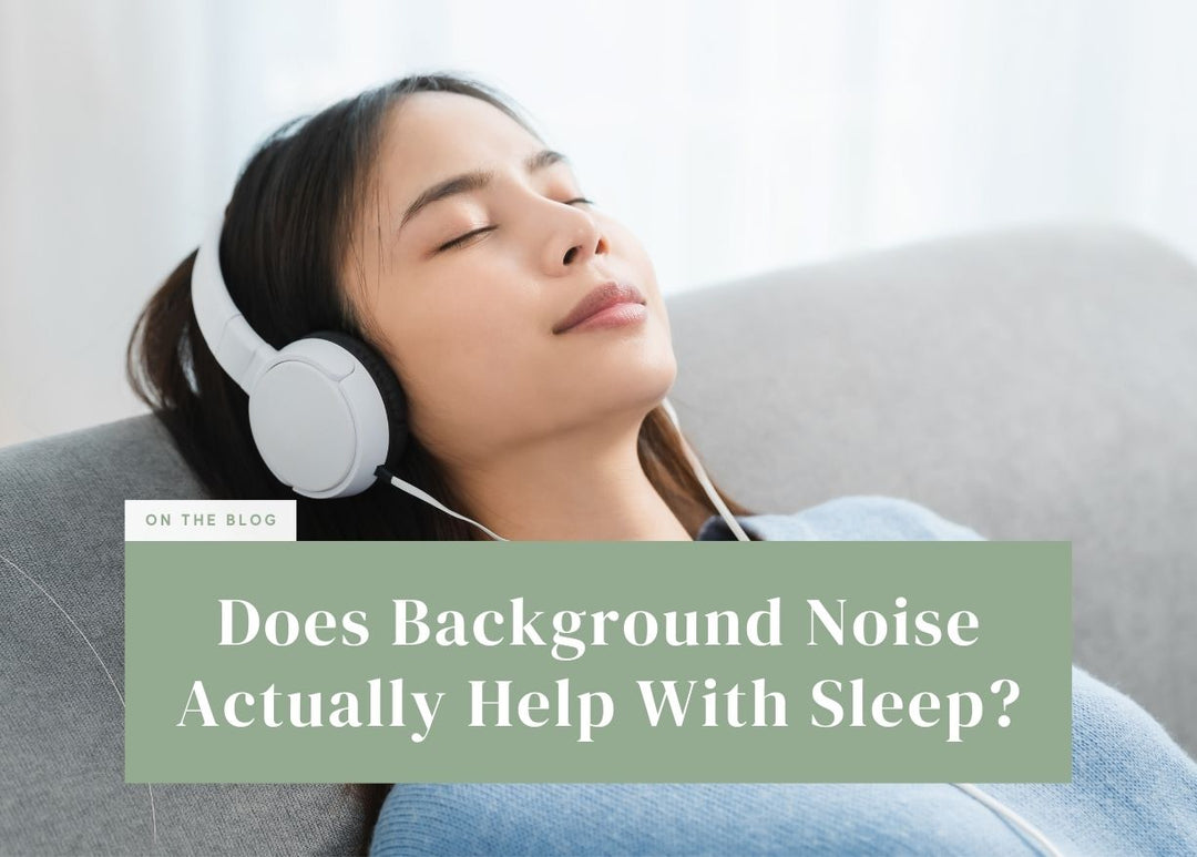 Woman resting comfortably on a sofa while listening through white over-ear headphones.
