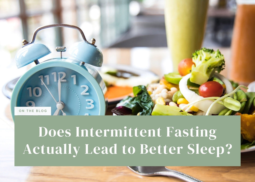 Light blue retro alarm clock set next to a fresh salad and healthy smoothies.