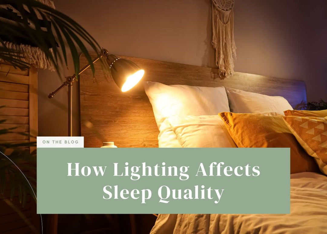 Warm reading lamp glowing beside a cozy bed with plush pillows.