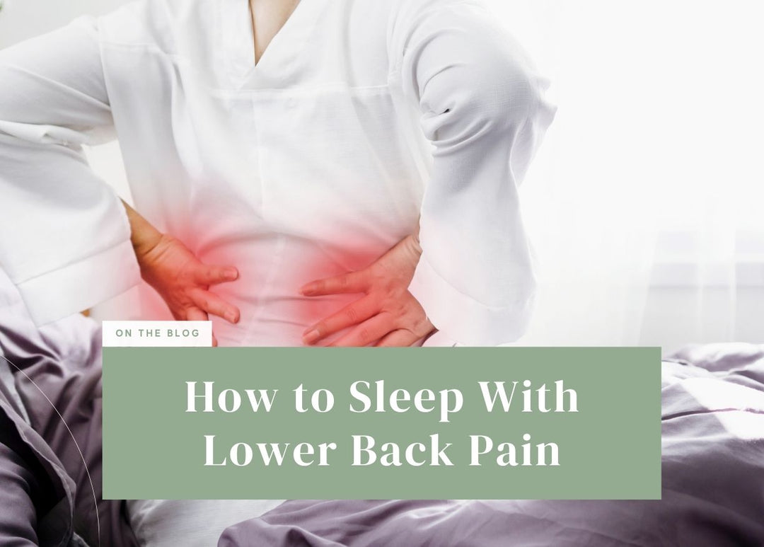 Person sitting up in bed clutching their glowing lower back in discomfort.