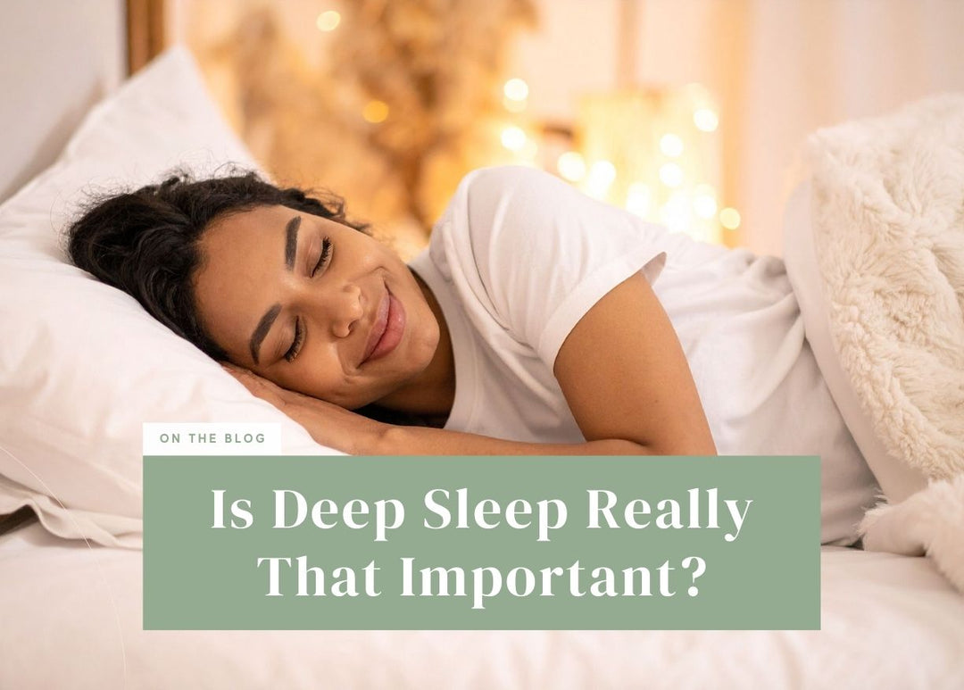 Smiling woman sleeping peacefully under a plush white blanket.