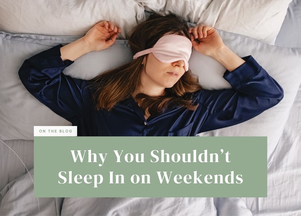 Top-down view of a woman lying in bed wearing a pink sleep mask.